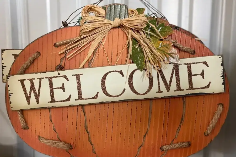 Welcome sign on pumpkin-themed decoration
