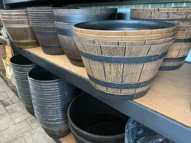 Wooden barrels displayed on shelves in a store.