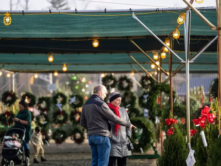 Countryview Farms Christmas Festive Activities People shopping at outdoor holiday market with wreaths.