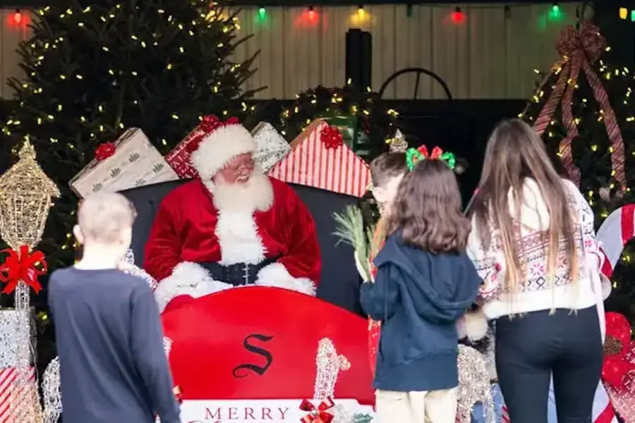 Santa Claus with children and Christmas decorations