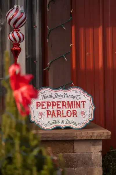 Peppermint Parlor candy shop sign outside decorated building.