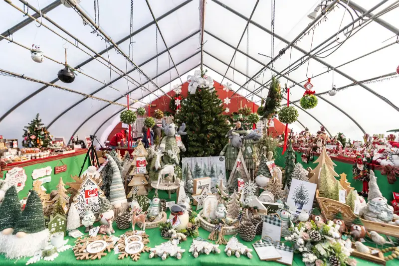 Christmas decorations displayed in greenhouse market.