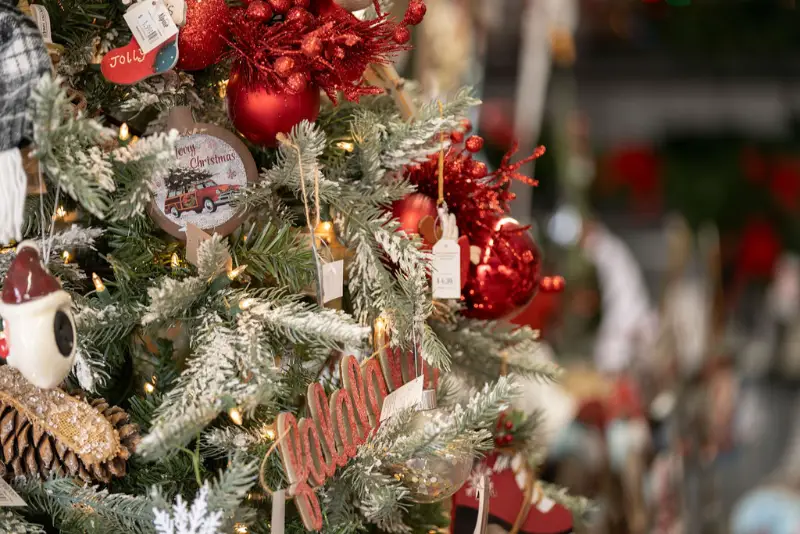 Festively decorated Christmas tree with red ornaments.