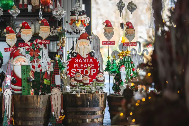 Festive holiday decorations with Santa and trees.