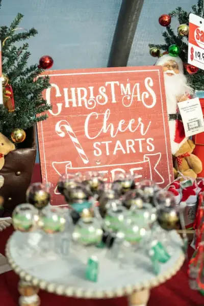 Christmas cheer sign with holiday decorations